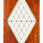 Colour photograph of Wheatstones Hatchment Dial which is set in wood organized in a diamond shape and marked with twenty letters