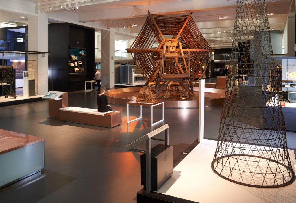 Colour photograph of a long view of the Information Age gallery showing the large Rugby Tuning Coil in the centre