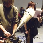 Aleks Kolkowski uses an old-looking Edison wax cylinder to record a girl's vocals