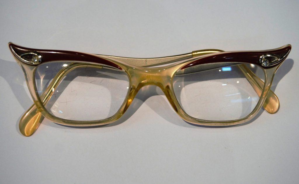 Colour photograph of a pair of hybrid Candida frame NHS spectacles