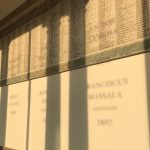 Colour photograph of an artistic installation showing text and projected shadows