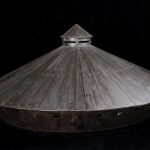 Colour photograph of a wooden model of a covered war chariot