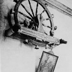 Black and white photograph of a holy wheel of carillon hanging on a wall
