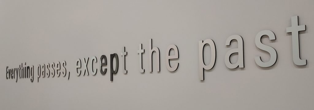 Colour photograph of a museum label that says everything passes except the past