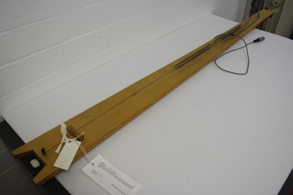 Colour photograph of springstring. A self built electro acoustic musical instrument by Hugh Davies