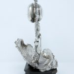 A photograph taken from the side, showing the silver clock