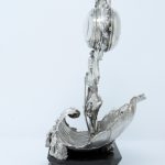 A photograph taken from the side showing the silver clock