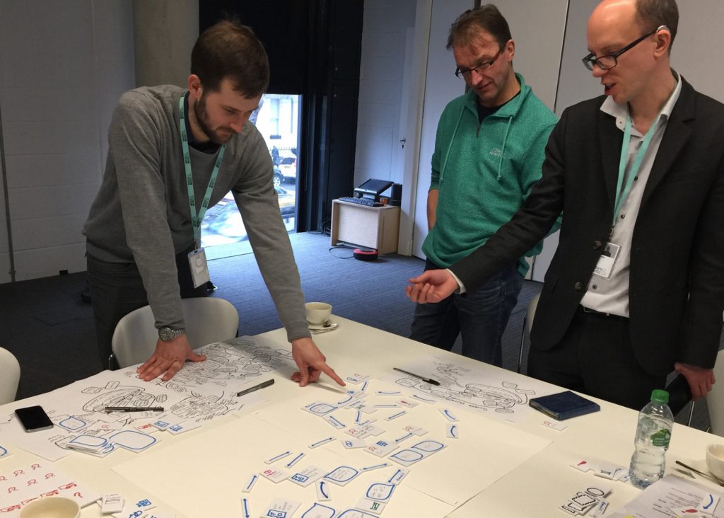 Museum staff look over notes and plans for a community mapping project