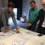 Museum staff look over notes and plans for a community mapping project