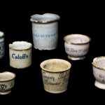 Colour photograph of various nineteenth century tin glazed earthenware dispensing pots