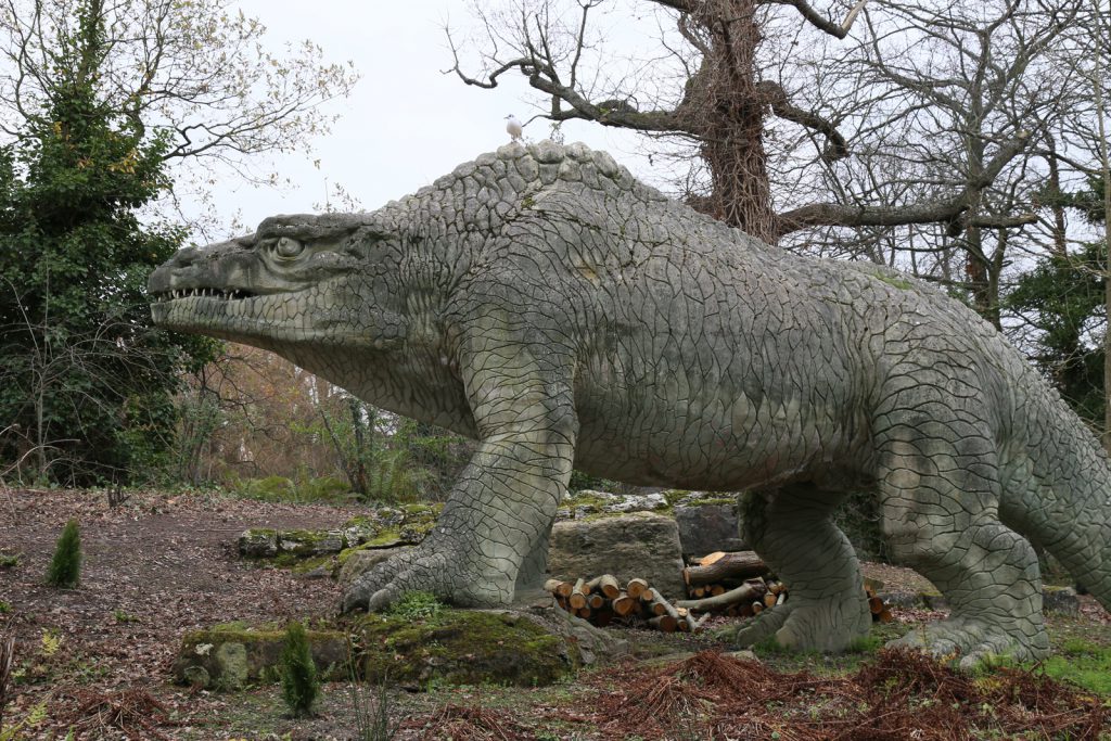 Colour photograph of a concrete megalosaur model from the nineteenth century