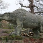Colour photograph of a concrete megalosaur model from the nineteenth century
