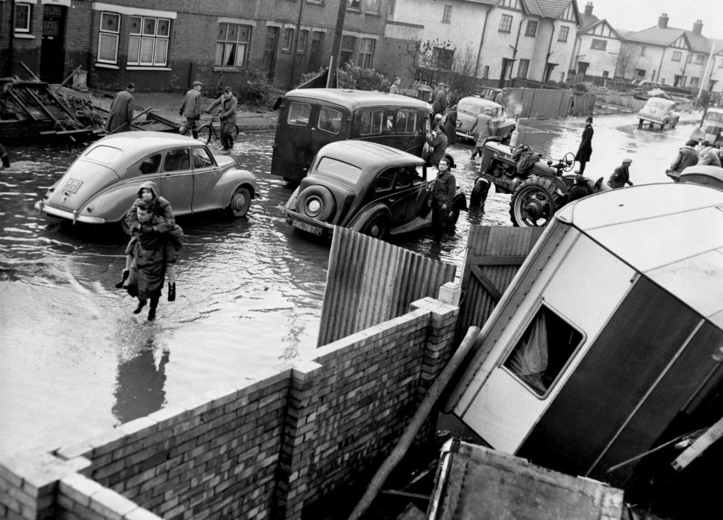 Black and white photograph of a flooded residential street in mid twentieth century