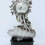 Photograph of the silver-cased clock, rear view