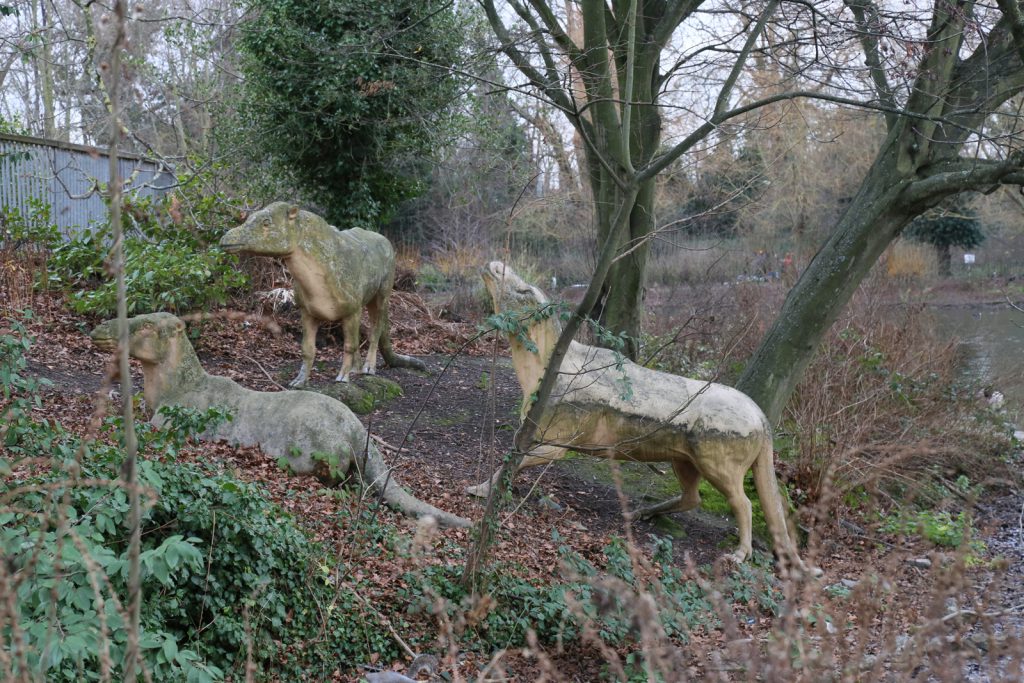 Colour photograph of three concrete anoplotherium models from the nineteenth century
