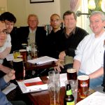 Colour photograph of Jeffs reading group sat inside a pub