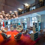 Colour photograph of the Wellcome Collections Reading Room which appears as a cross between a library and a museum gallery
