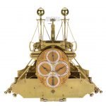 A large ornate brass chronometer with four dials on the face