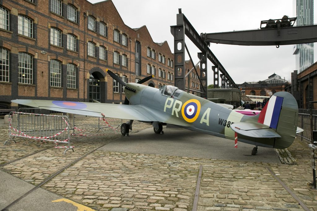 Colour photograph of a renovated Spitfire aircraft outside the Museum of Science and Industry
