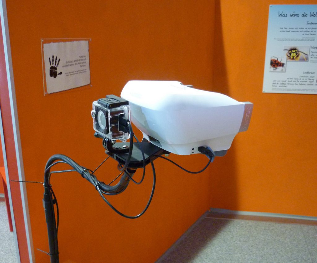 Colour photograph of a viewing eyepiece that simulates vision without colour