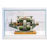 Colour photographs of a steam engine model a dial current generator and an internal combustion engine on display