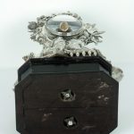 Silver-cased clock, underside of base showing contemporary fixings