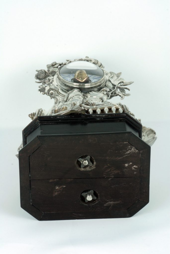 Silver-cased clock, underside of base showing contemporary fixings