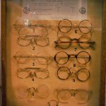 Colour photograph of a display case showing various styles of NHS spectacles