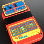 Colour photograph of a speak and spell childrens toy that has been modified to create music