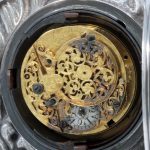 The back of the watch movement of the small clock signed 'H Perry Dean Street St Anns London'