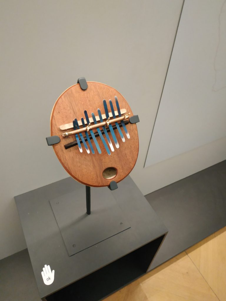 Colour photograph of a Kalimba instrument in a museum gallery