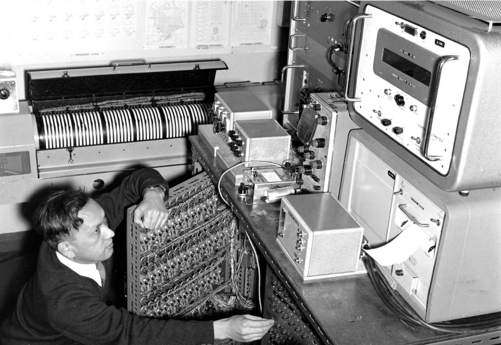 Black and white photograph of Shizuo Ishiguro with his electronic storm surge modelling machine