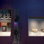 Colour photograph of the empathetic ear display in Information Age showing Samaritans posters and landline telephones