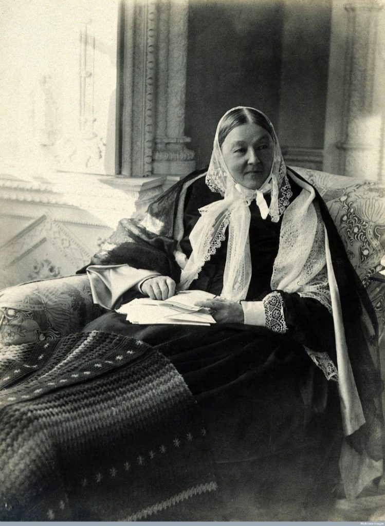 Black and white full figure seated portrait photograph of Florence Nightingale