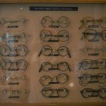 Colour photograph of a 1950 display case showing various styles of NHS spectacles