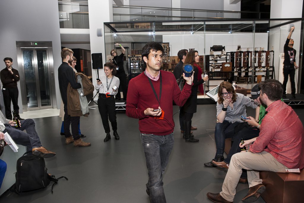 Colour photograph of a number of people taking part in the set up of a live performance in the Information Age gallery