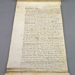 Old  legal document scroll showing calligraphic writing in old English