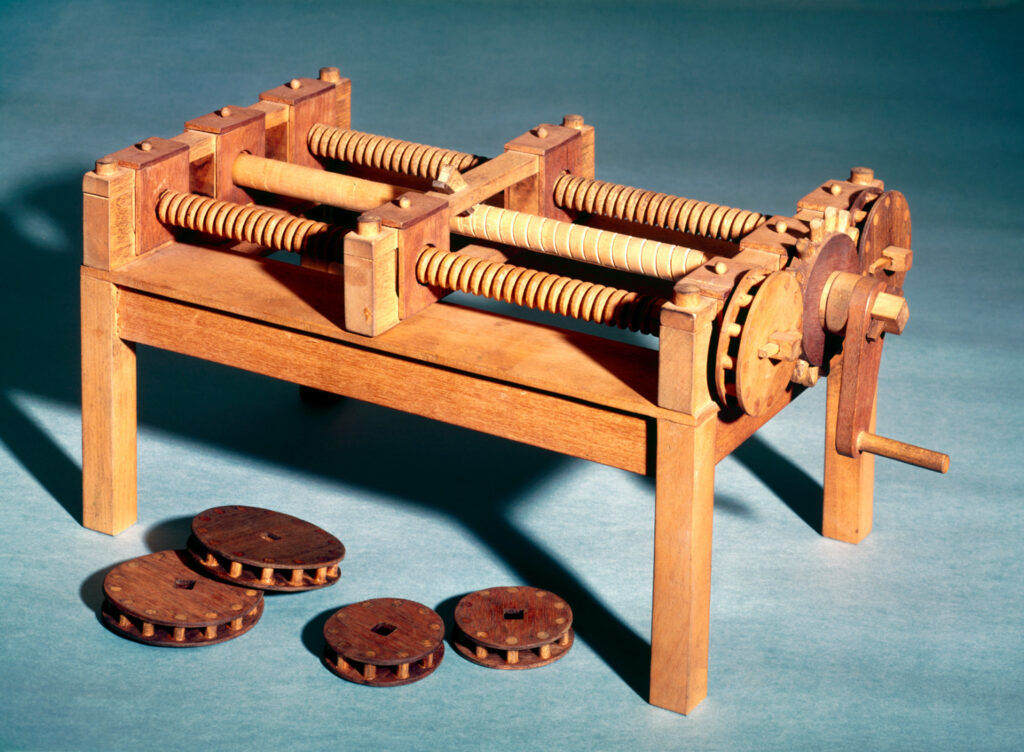Colour photograph of a working wooden model of a machine for cutting wooden screws