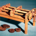 Colour photograph of a working wooden model of a machine for cutting wooden screws