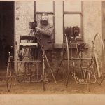 Photographer with two tricycles and two glass plate cameras on tripods from the late nineteenth century