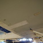Colour photograph of the underside of the Vickers Vimy aircraft showing numerous patches applied during conservation