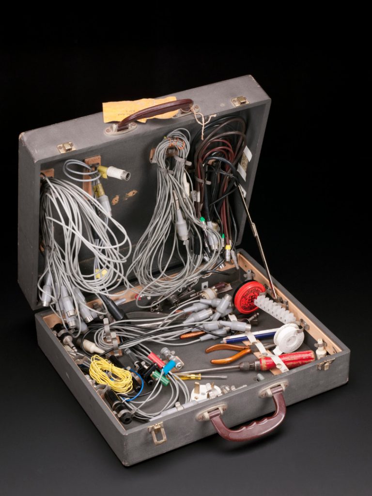 A suitcase containing a variety of small electrical tools