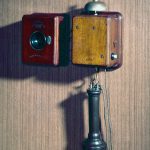 Colour photograph of a wall mounted telephone that uses an Blake transmitter from the 1880s
