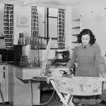Black and white early twentieth century photograph of a woman ironing