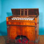 Colour photograph of a Wheatstone concertina instrument fashioned in wood