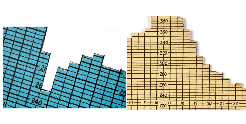 Colour photograph of two individual chart cards from a 1950s three dimensional chart showing electricity demand over time