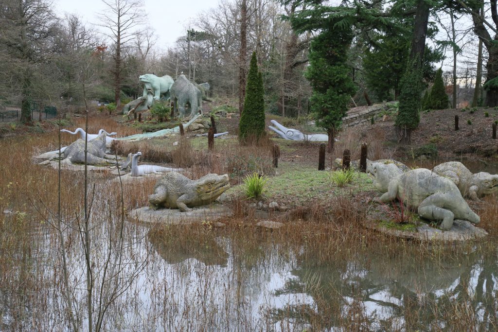 Colour photograph of a number of concrete extinct species models from the nineteenth century