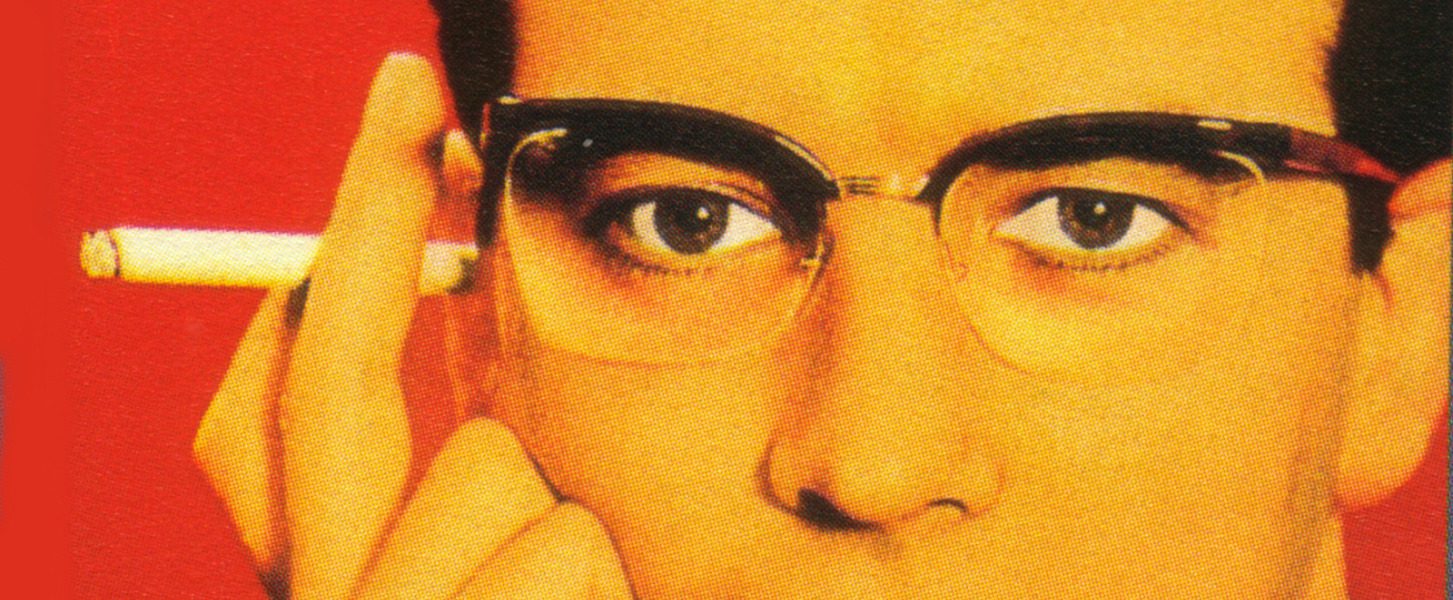 Colour print advertisement showing a man wearing Nylor supra frame spectacles and holding a cigarette