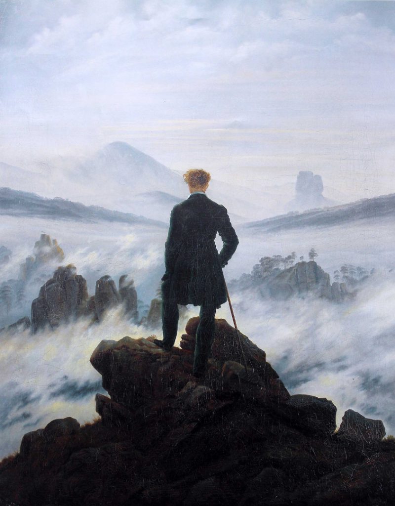 Oil painting from 1818 of a man standing atop a mountain and looking into the cloudy distance