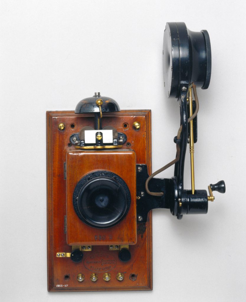 Colour photograph of a wall mounted telephone that uses an Edison chalk receiver from the early 1900s